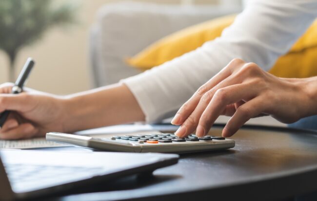 AdobeStock_571318243 person doing taxes with a calculator | Lemasters, CPA is a specialized accounting firm in Northwest Florida providing premier business valuations, litigation support, and tax services